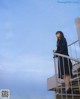 A woman standing on the steps of a building.