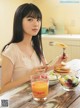 A woman sitting at a table with a plate of food.